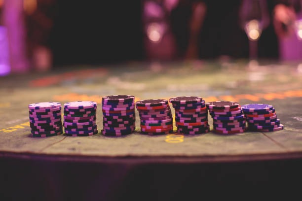 Close-up of live-dealer table layout with cards and chips during an active baccarat game session